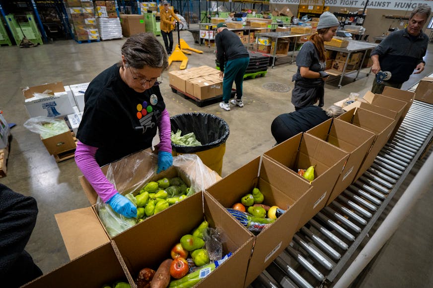 Laura Wennik, a volunteer with the Food Group, helps pack pears into produce boxes during the food bank's "Pack to the Max" event on the 15th annual Give to the Max Day at the Food Group in New Hope on Thursday. This day is the biggest one-day fundraiser for thousands of Minnesota schools and nonprofits and the Food Group is hoping to raise at least $100,000 by the end of the day. They are also distributing the boxes to food shelves and other affordable grocery programs in Minnesota to get healthy food in the hands of people in need.