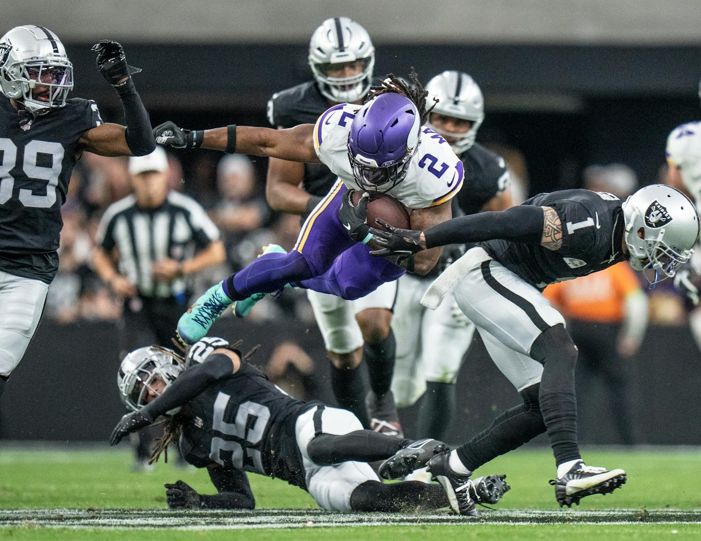 Minnesota Vikings running back Alexander Mattison (2) jumped over Las Vegas Raiders safety Tre'von Moehrig (25) picking up a first down in the second quarter Sunday December ,10 ,2023 in,Las Vegas, Nev. ] JERRY HOLT • jerry.holt@startribune.com