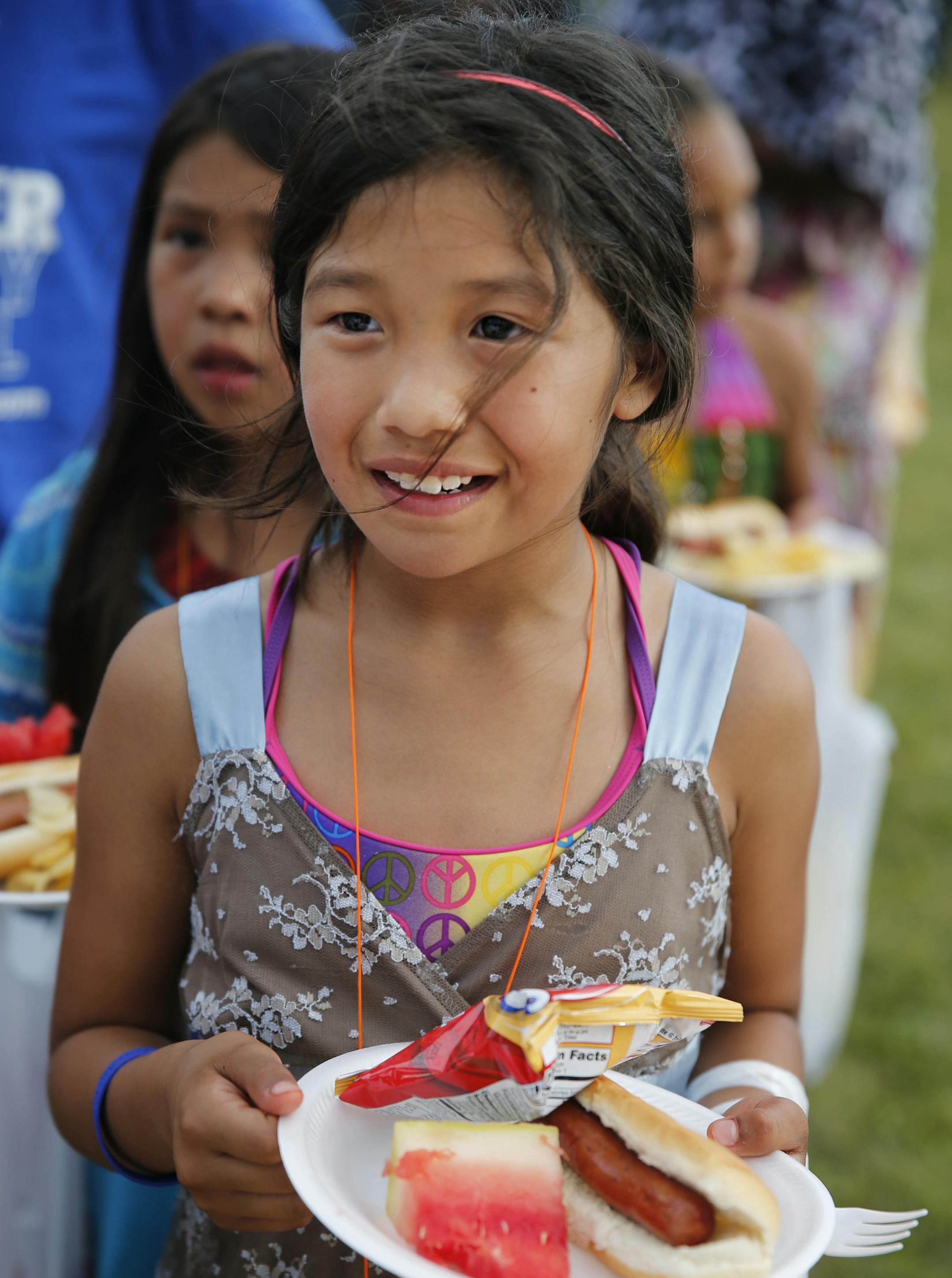 In the Heritage Park neighborhood in Minneapolis, Autumn Merrick, 10, got some free summer picnic fare.