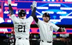 The Tigers' Jake Rogers, right, is greeted by Mark Canha after scoring during the fifth inning Friday night against the Twins.