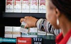 A worker places low-nicotine cigarettes on a shelf at a Circle K store in Chicago on June 21, 2022.