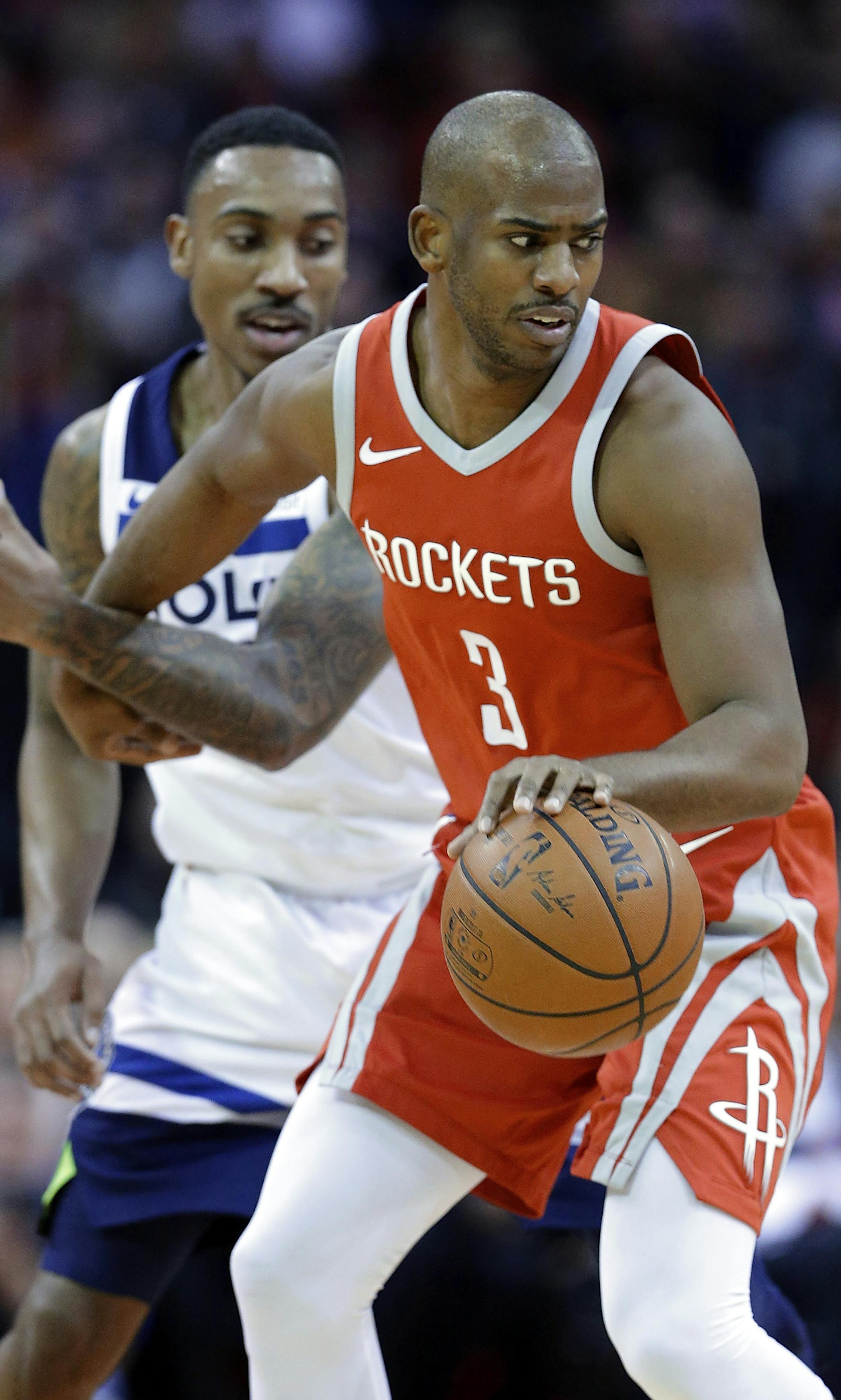 Houston Rockets guard Chris Paul (3) tangles with Minnesota Timberwolves guard Jeff Teague (0) as he pivots during the first half of an NBA basketball game Thursday, Jan. 18, 2018, in Houston. (AP Photo/Michael Wyke)