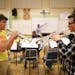Ben Klepfer, left, and Quincy Erickson warmed up their trumpets after coming back to the rehearsal room after a break.