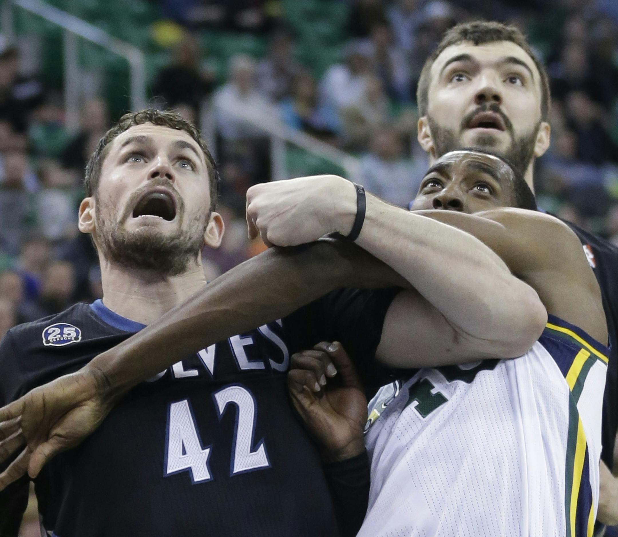 Utah Jazz's Jeremy Evans (40) battles under the boards with Minnesota Timberwolves' Kevin Love (42) and teammate Nikola Pekovic, of Montenegro, in the second quarter during an NBA basketball game, Tuesday, Jan. 21, 2014, in Salt Lake City. (AP Photo/Rick Bowmer)