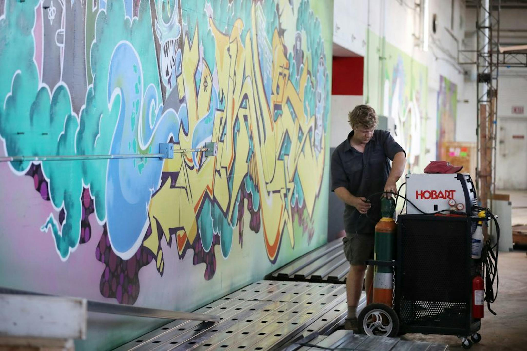 Can Can Wonderland, featuring an artist-designed 18-hole mini golf course, and programs to connect diverse residents, received $75,000 to increase vibrancy in St. Paul's Creative Enterprise Zone. Levi Houkom, the project manager for the mini gold area of Can Can Wonderland, worked on the course on June 16, 2016.