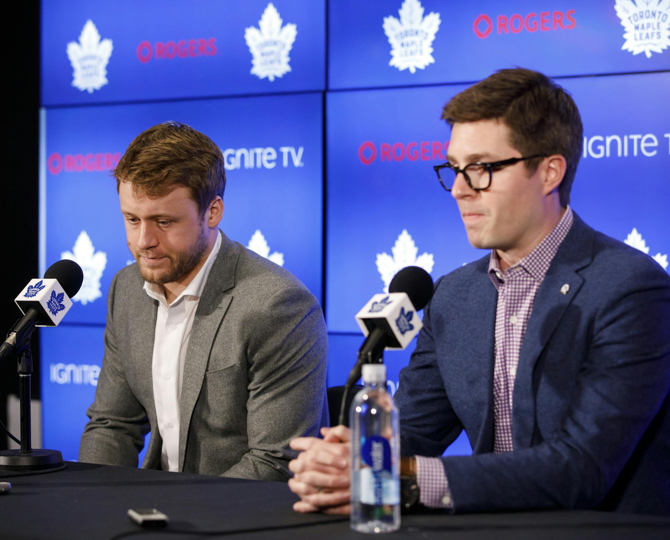 Toronto Maple Leafs defenseman Morgan Rielly, left, and general manager Kyle Dubas pause during a press conference, Tuesday, March 12, 2019, in Toronto, as they address an NHL investigation into an alleged slur used during an NHL hockey game the night before against the Tampa Bay Lightning. (Cole Burston/The Canadian Press via AP)