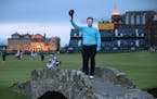 United Statesí Tom Watson doffs his cap as he poses on the Swilcan Bridge for photographers during the second round of the British Open Golf Champion