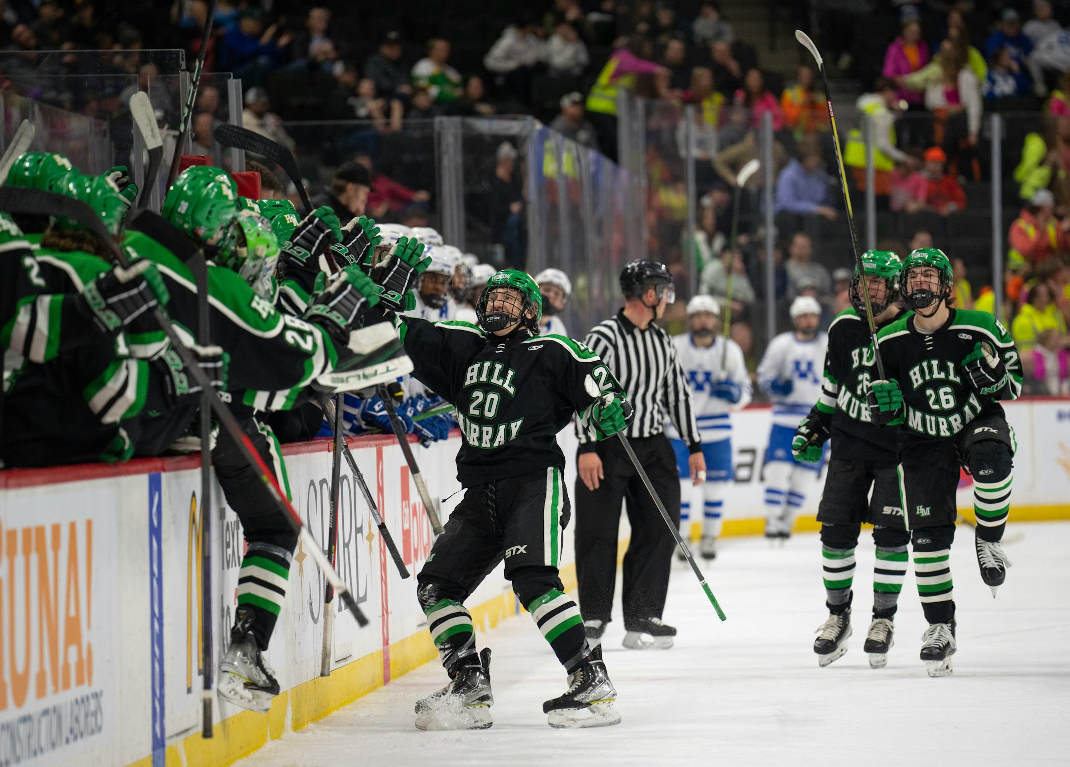Hill-Murray Pioneers defenseman Landon Cottingham (20) skated to the bench to celebrate his goal in the first period.