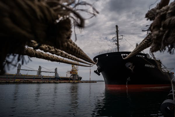 A ship carrying grain waited in port in Odessa, Ukraine. The country’s agricultural and mineral riches have been put at risk by the Russian invasion
