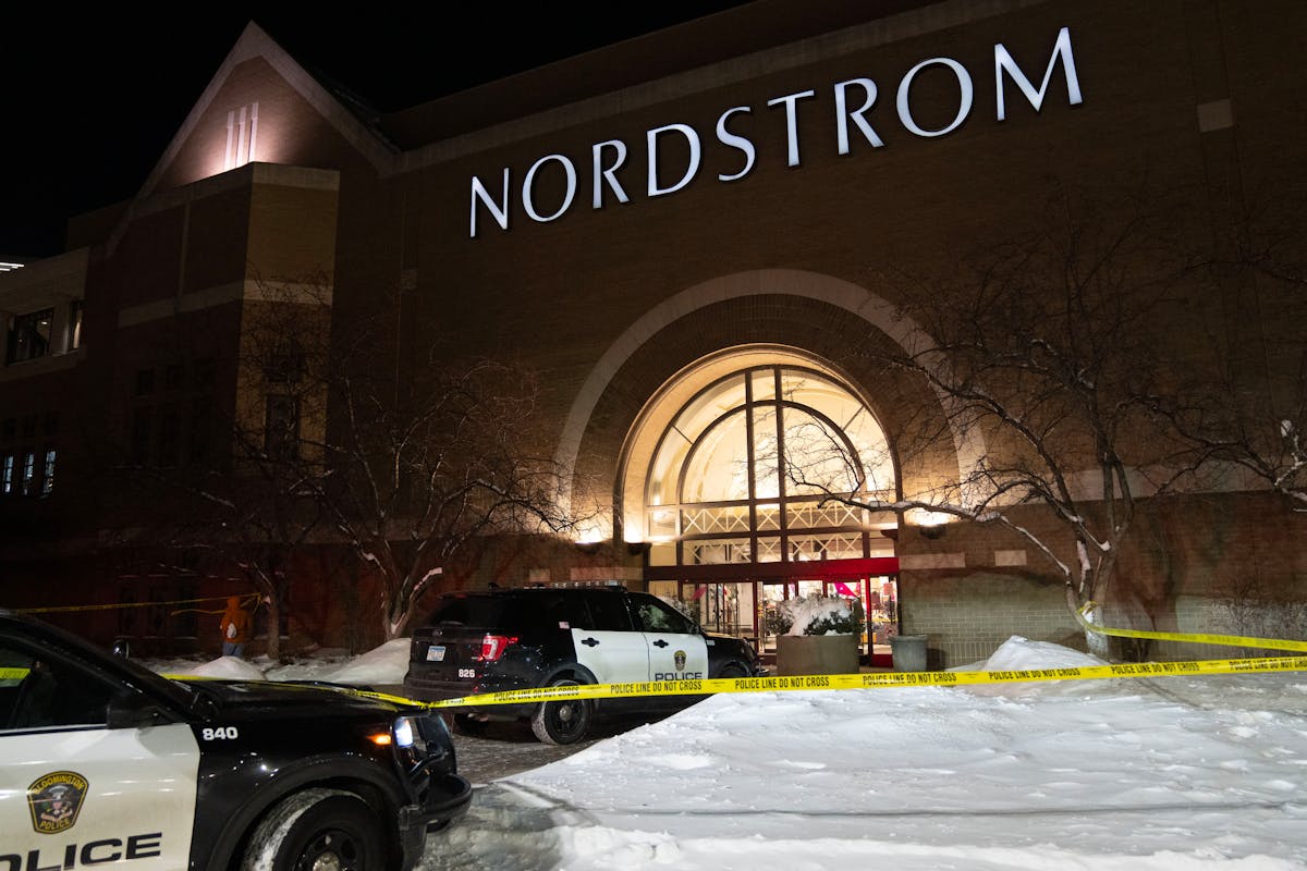 Police cars and tape at night with snow outside Nordstrom store at the Mall of America on Dec. 23, 2022.