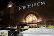 Police cars and tape at night with snow outside Nordstrom store at the Mall of America on Dec. 23, 2022.