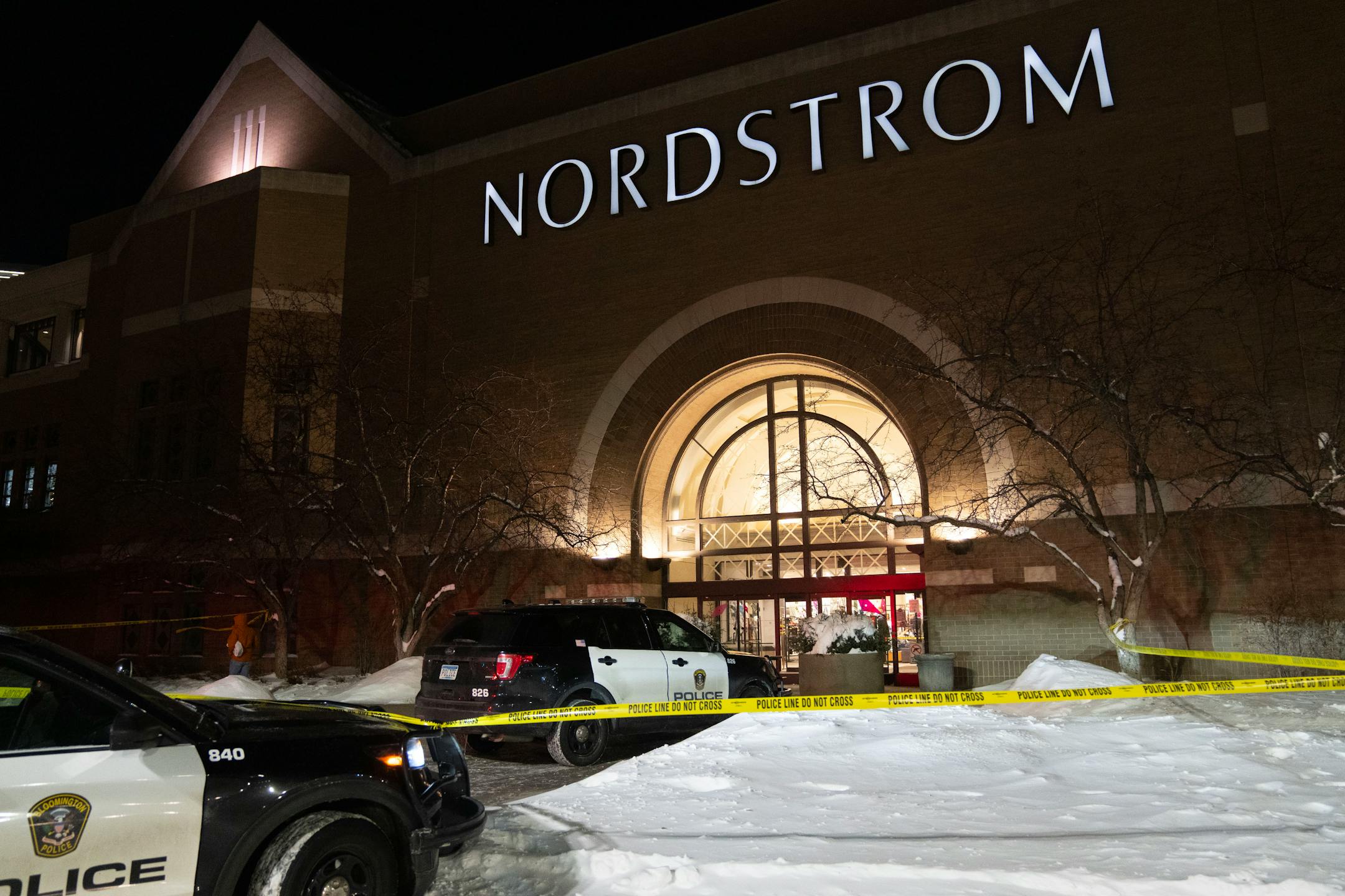 Police cars and tape at night with snow outside Nordstrom store at the Mall of America on Dec. 23, 2022.