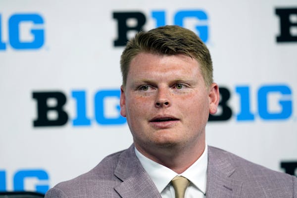 Minnesota offensive lineman John Michael Schmitz talks to reporters during an NCAA college football news conference at the Big Ten Conference media da