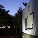 The Facebook "like" symbol is illuminated on a sign outside the company's headquarters in Menlo Park, Calif., Friday, June 7, 2013. A leaked document 
