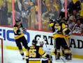 Pittsburgh Penguins' Brian Dumoulin (8) and Carter Rowney (37) celebrate with Nick Bonino after Bonino's goal against the Nashville Predators during t
