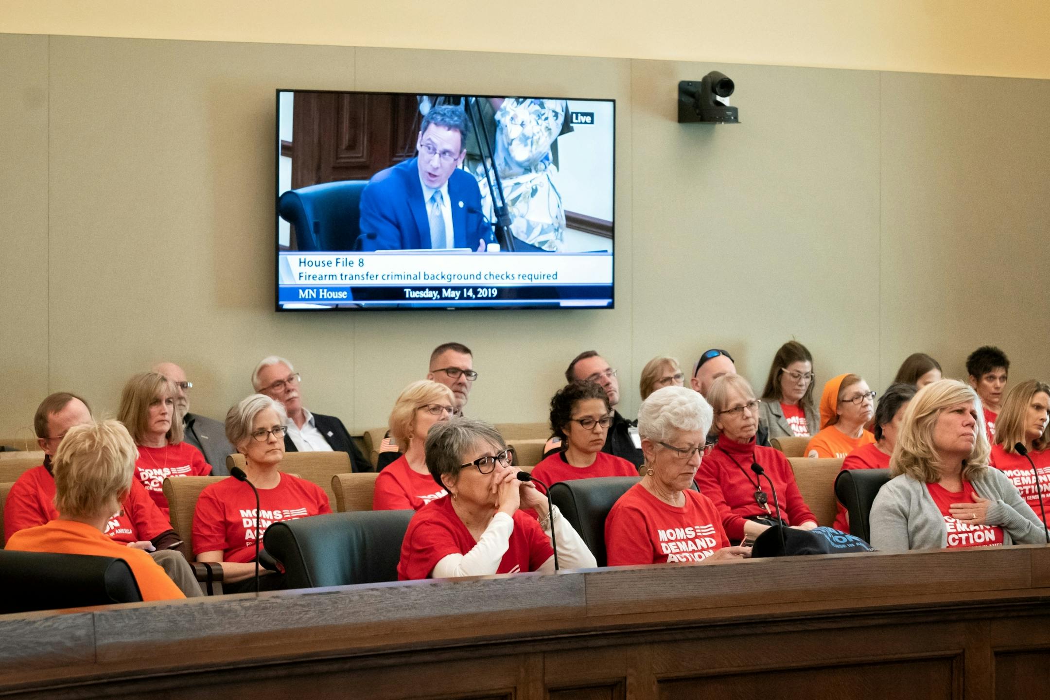 The overflow room for the Public Safety conference committee held mostly members of Moms Demand Action members. On the screen is Sen. Ron Latz, D-St. Louis Park.