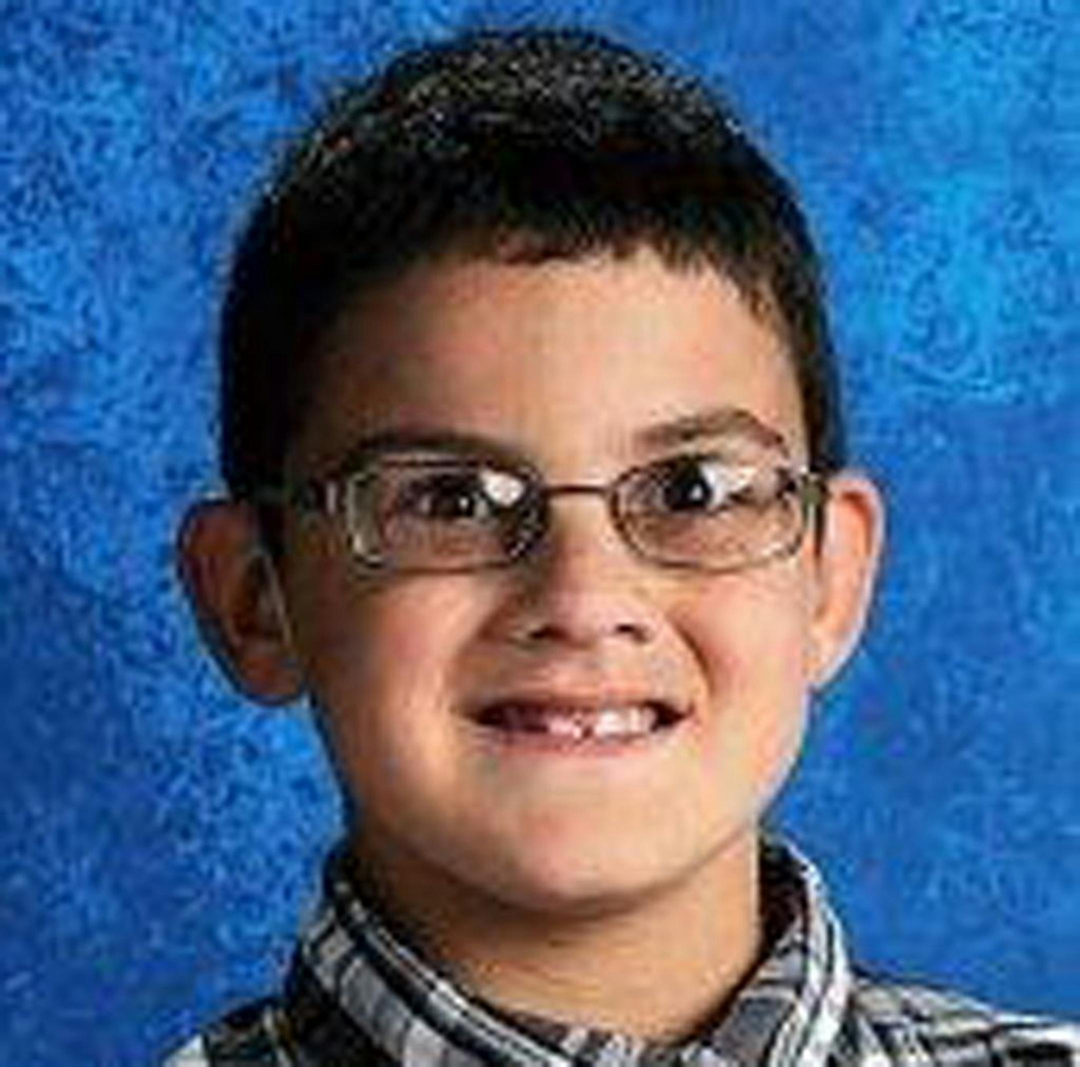 This undated photo provided by Lifetouch shows Devin Aryal, 9, of Oakdale, Minn. Police say Nhan Lap Tran of Oakdale was arrested Monday, Monday, Feb. 11, 2013 on suspicion of second-degree murder and first-degree assault in connection with the shooting death of the fourth-grader and the wounding of his mother who had just picked him up from daycare.
