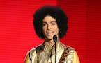 FILE - In this Nov. 22, 2015 file photo, Prince presents the award for favorite album - soul/R&B at the American Music Awards in Los Angeles. Pop icon