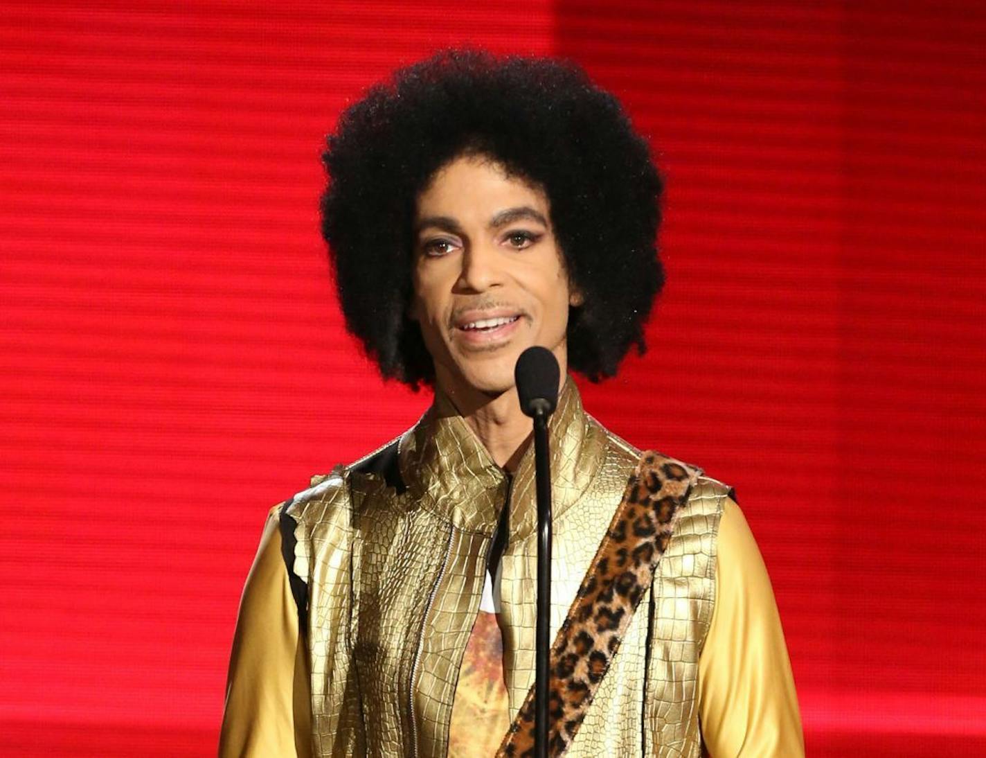 FILE - In this Nov. 22, 2015 file photo, Prince presents the award for favorite album - soul/R&B at the American Music Awards in Los Angeles. Pop icon Prince is writing a memoir to be released next year. Publisher Spiegel & Grau announced Friday, March 18, 2016, it has acquired Prince�s untitled book, which will be released in the fall of 2017.