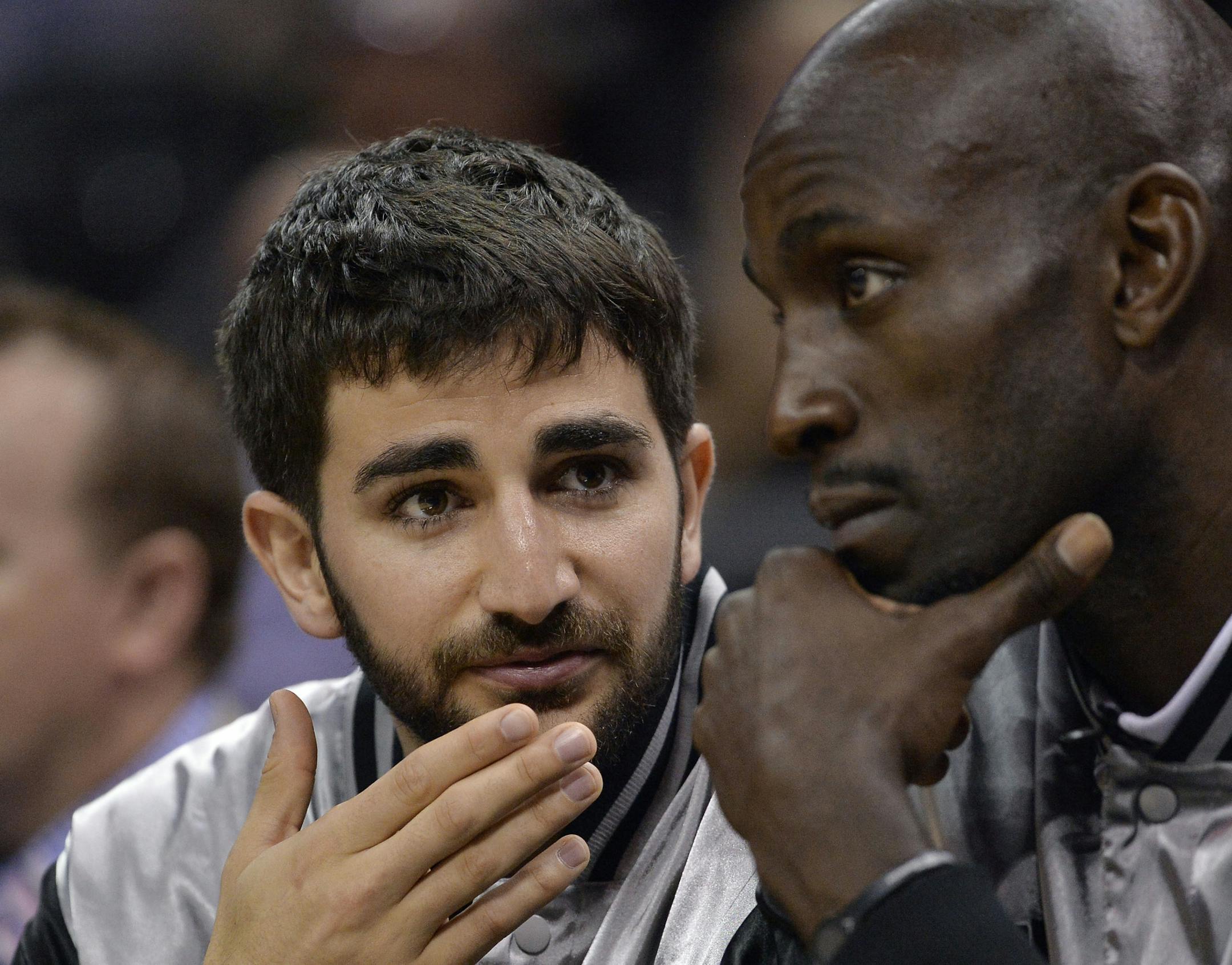 Minnesota Timberwolves guard Ricky Rubio, left, of Spain, speaks with Timberwolves forward Kevin Garnett during the second half of an NBA basketball game against the San Antonio Spurs, Sunday, March 15, 2015, in San Antonio. San Antonio won 123-97. (AP Photo/Darren Abate)