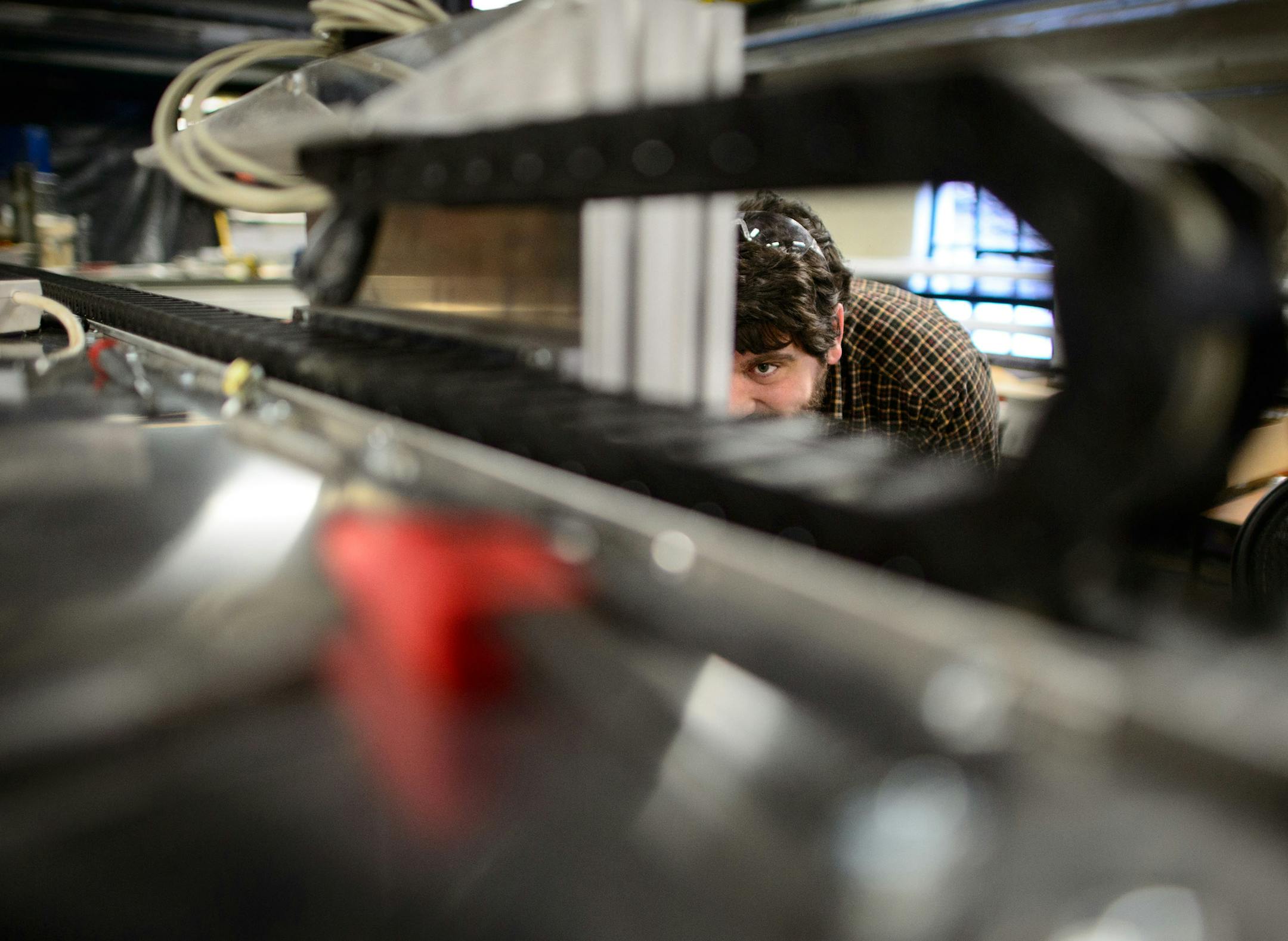 Erik Steen, applied engineering researcher at the St. Anthony Falls Lab worked on a instrumentation cart he designed and built for precision data collection of topographical experiments. ] GLEN STUBBE * gstubbe@startribune.com Friday, March 14, 2014. The St. Anthony Falls Lab has built and repaired a lot of their own lab equipment and tech for other labs, and a researcher there, Chris Ellis, believes you don't need a lot of money or fancy tech to do good research.