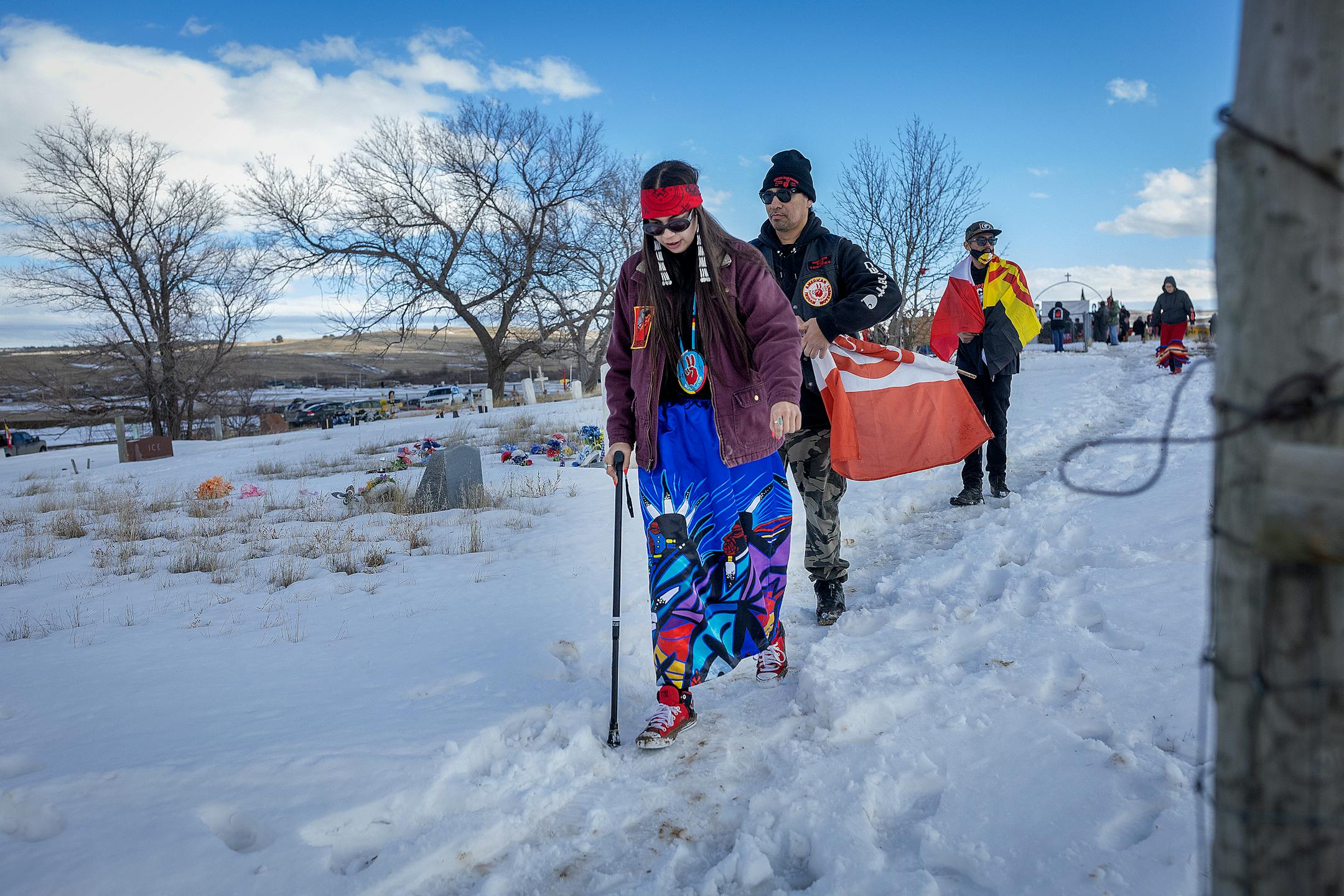American Indian Movement Minnesota member Rachel Thunder makes her way to join a gun salute to honor the 1973 Wounded Knee Occupation in Wounded Knee, SD on the 50th anniversary.