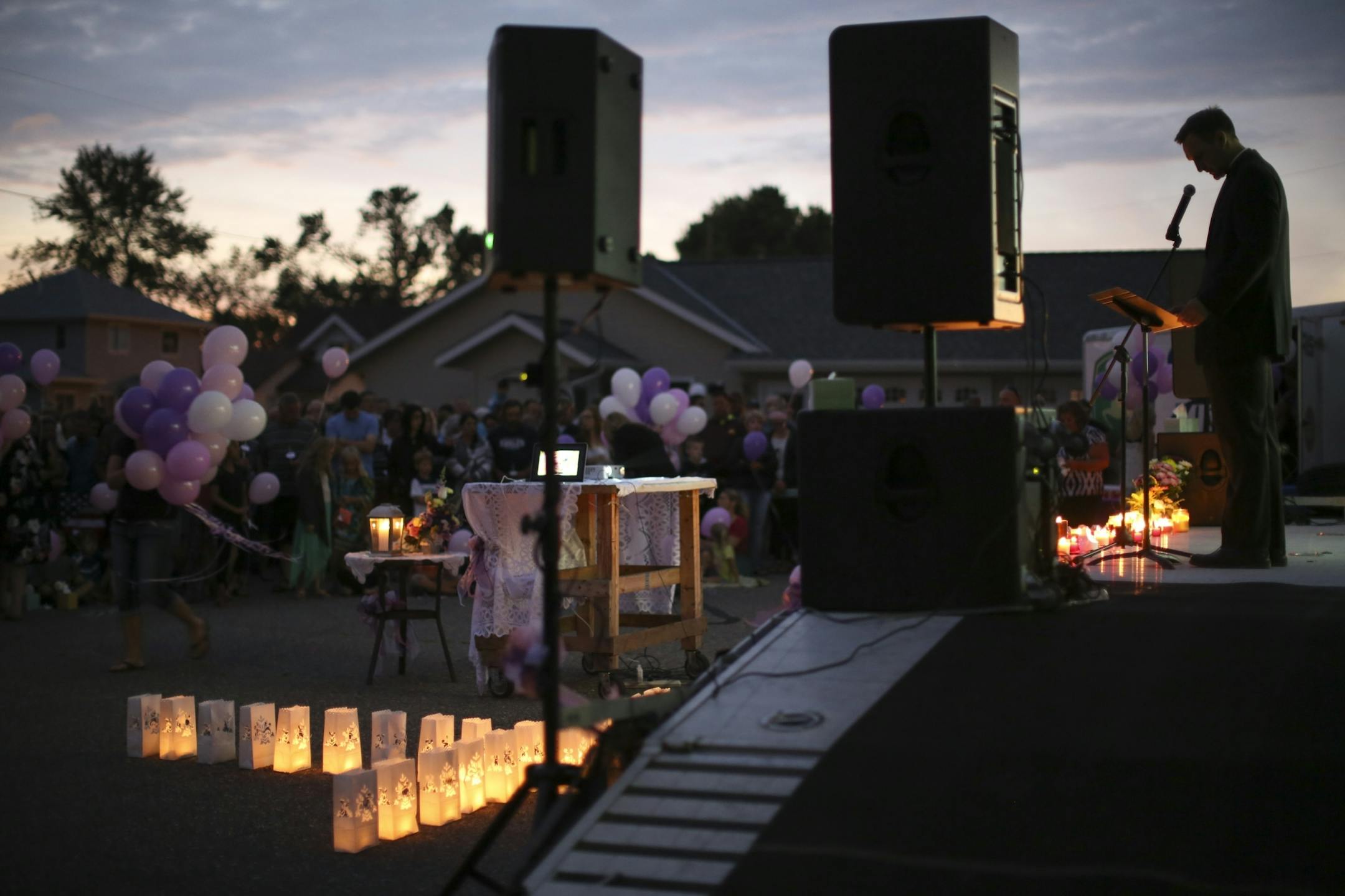 Fr. Aaron Nett led the prayer vigil for Alayna Ertl Tuesday night in the parking lot of St. Anthony Church in Watkins.