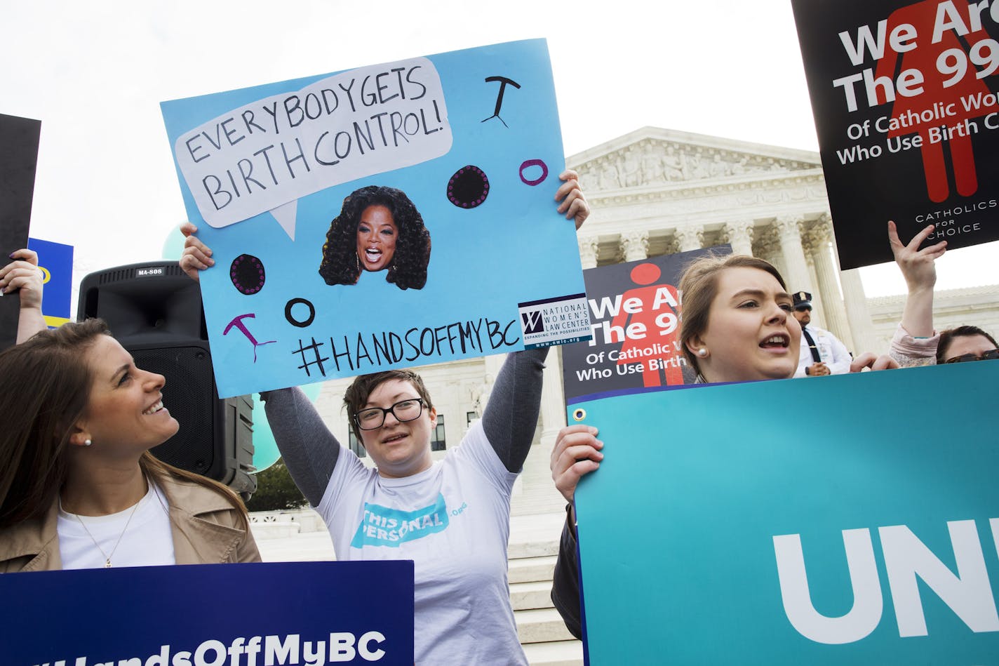 Erin Longbottom, left, holds up a sign in support of birth control access during a rally outside the Supreme Court in Washington, Wednesday, March 23, 2016, as the court hears arguments to allow birth control in healthcare plans in the Zubik vs. Burwell case. The Supreme Court seems deeply divided over the arrangement devised by the Obama administration to spare faith-based groups from having to pay for birth control for women covered under their health plans. (AP Photo/Jacquelyn Martin)