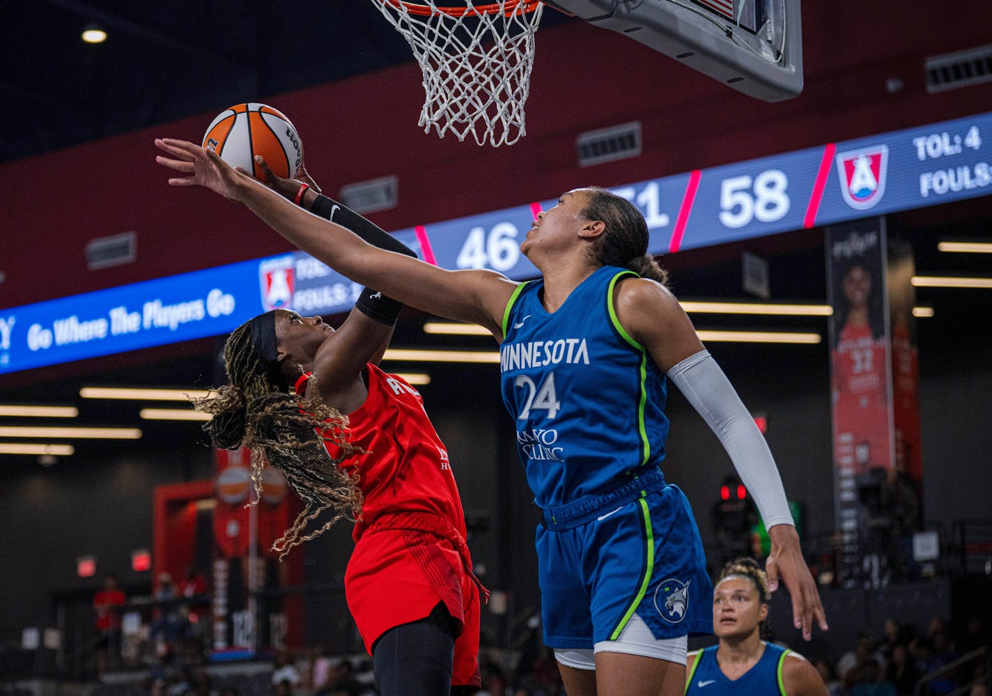 Atlanta Dream guard Rhyne Howard goes for a layup while guarded by Minnesota Lynx's Napheesa Collier (24) during a WNBA basketball game Tuesday, July 18, 2023, in College Park, Ga. (Matthew Pearson/WABE via AP)