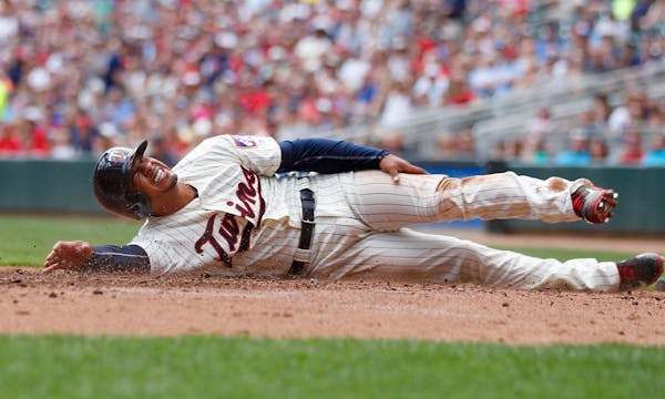 Minnesota Twins Eduardo Escobar is hurt as he scores in the first inning against the Texas Rangers during a baseball game on Saturday, July 2, 2016 in