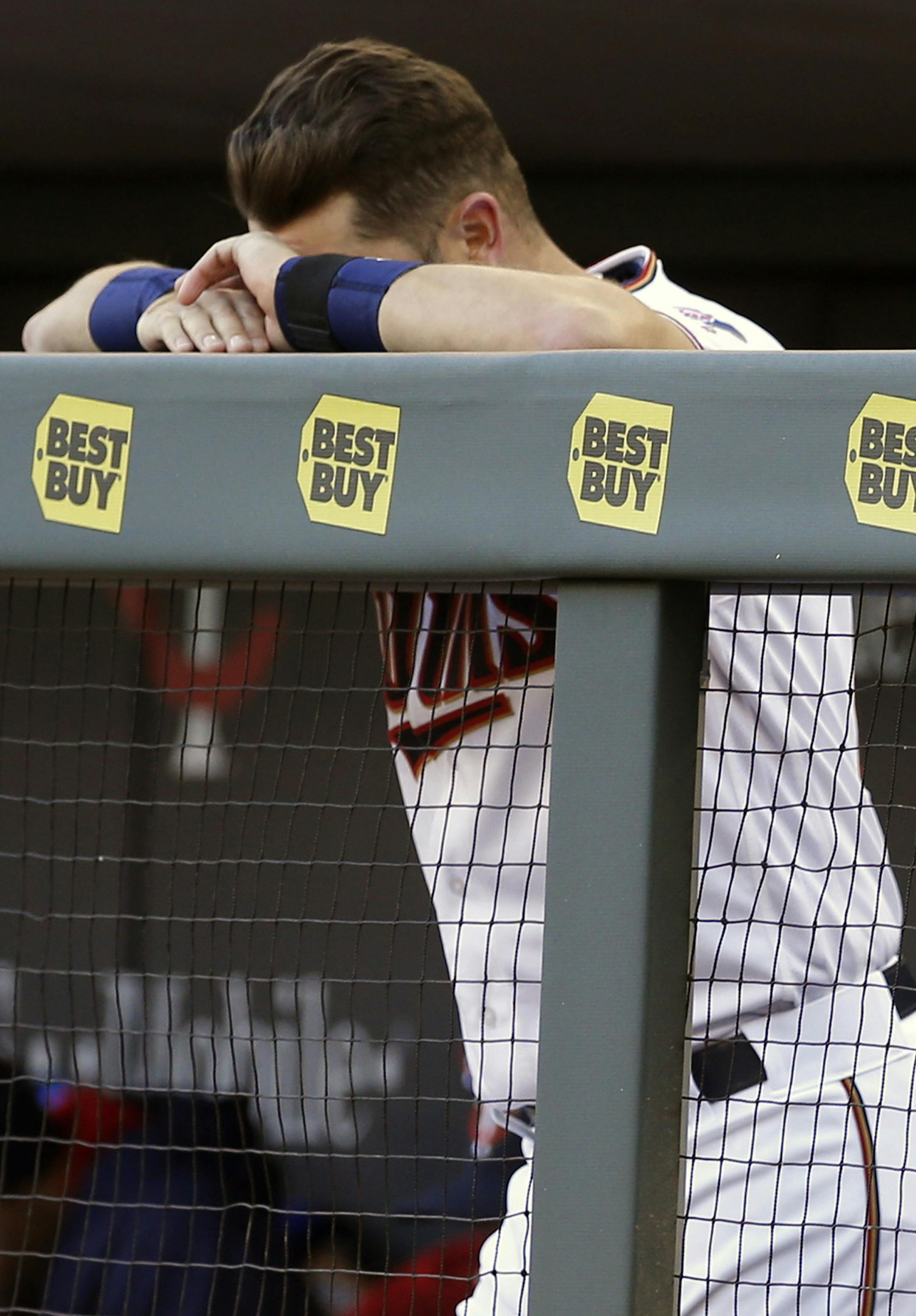 FILE - In this April 11, 2016 file photo, Minnesota Twins' Trevor Plouffe rests his head on his hands in the final minutes of a baseball game against the Chicago White Sox in Minneapolis. The White Sox won 4-1, handing the Twins their seventh loss against no wins for the young season. (AP Photo/Jim Mone,File) ORG XMIT: MIN2016041220084342