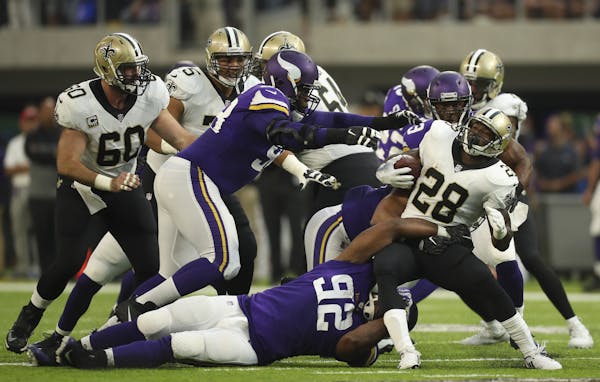 New Orleans Saints running back Adrian Peterson (28) was tackled by Minnesota Vikings defensive tackle Tom Johnson (92) after a first quarter run. ] J