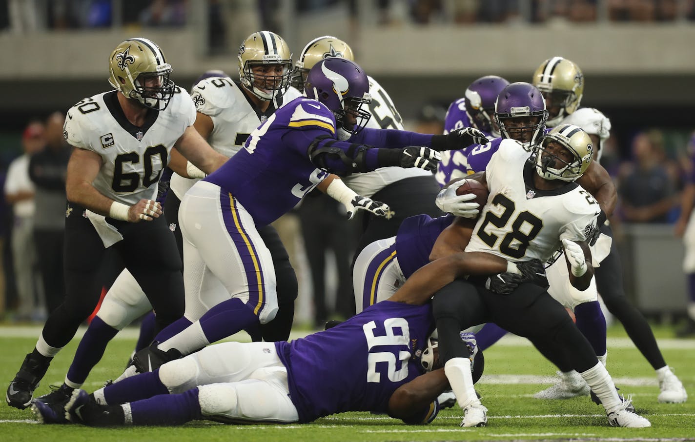 New Orleans Saints running back Adrian Peterson (28) was tackled by Minnesota Vikings defensive tackle Tom Johnson (92) after a first quarter run. ] JEFF WHEELER &#xef; jeff.wheeler@startribune.com The Minnesota Vikings faced the New Orleans Saints in their season opener NFL football game on Monday night, September 11, 2011 at U.S. Bank Stadium in Minneapolis.