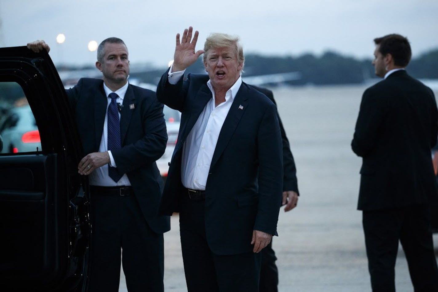 U.S. President Donald Trump yells to reporters after arriving at Andrews Air Force Base after a summit with North Korean leader Kim Jong Un in Singapore, Wednesday, June 13, 2018, in Andrews Air Force Base, Me.