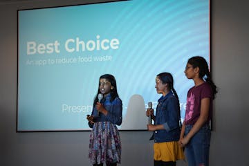 Grace Kaspar, left, Bhavagna Thumbeti, center, and Aadhya Sambhangi gave a presentation on the app they created to help reduce food waste. They were o