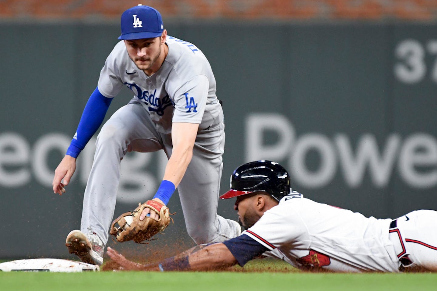 Atlanta Braves' Eddie Rosario dives into second base ahead of the tag by Los Angeles Dodgers second baseman Trea Turner off a pop out by Freddie Freeman during the eighth inning in game two in the 2021 National League Championship Series at Truist Park on Sunday, Oct. 17, 2021 in Atlanta. (Wally Skalij/Los Angeles Times/TNS) ORG XMIT: 29855247W