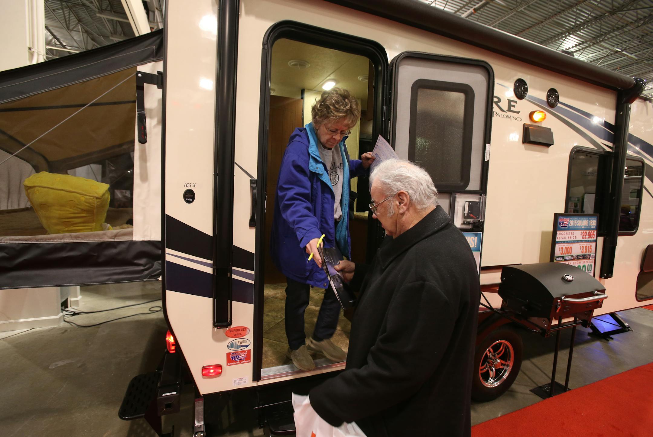 George Wainz and his wife, Hope, check out a Solaire camper at the Camper and RV Show held at the Suburban Collection Showplace in Novi, Mich., on Thursday, Feb. 5, 2015. (AP Photo/Detroit Free Press, Kirthmon F. Dozier) DETROIT NEWS OUT; NO SALES