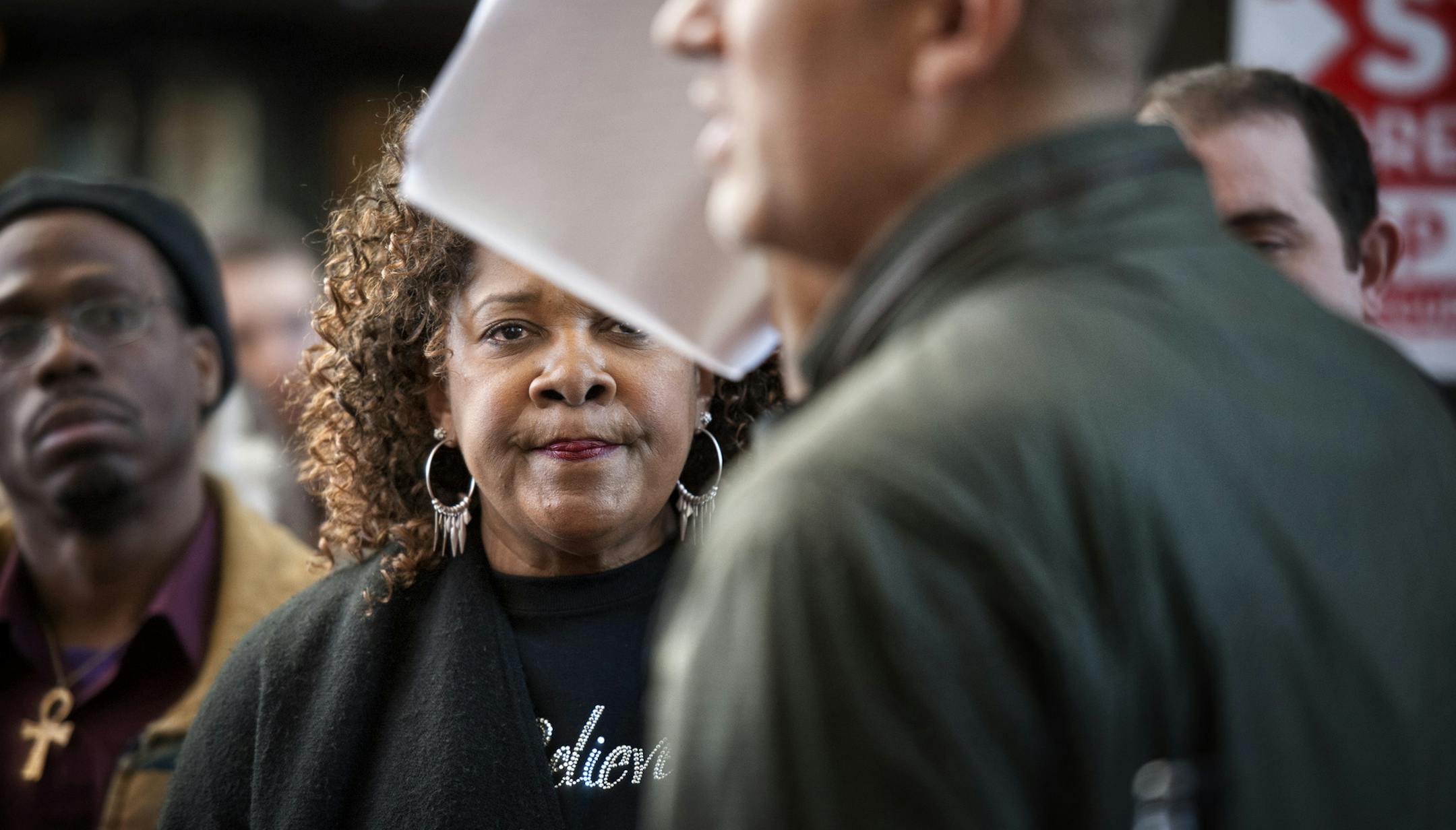 Rose McGee looked on as supporter Anthony Newby waved the petitions he was about to deliver to the U.S. Attorney to Minnesota before Rose headed upstairs to her court hearing. Housing activists marched a petition with about 330,000 signatures to U.S. Department of Justice offices across the country on Tuesday, calling on President Barak Obama to break up the big banks and prosecute their executives. The petition, signed by an estimated 2,600 Minnesotans, was headed to the Minneapolis office of B
