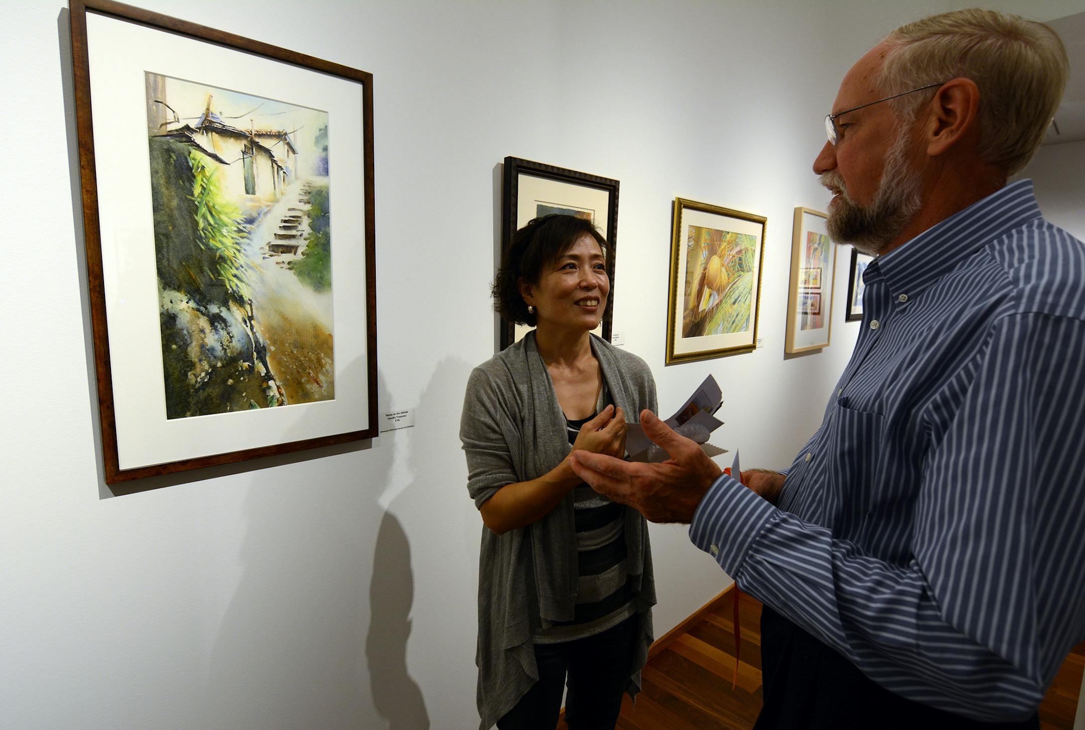 Claudia Trepanier, of Lakeville, discussed her painting with Steve Lackore, of Rochester. Both artists earned awards at the Minnesota Watercolor Society fall exhibition reception. Photo by Liz Rolfsmeier, Special to the Star Tribune