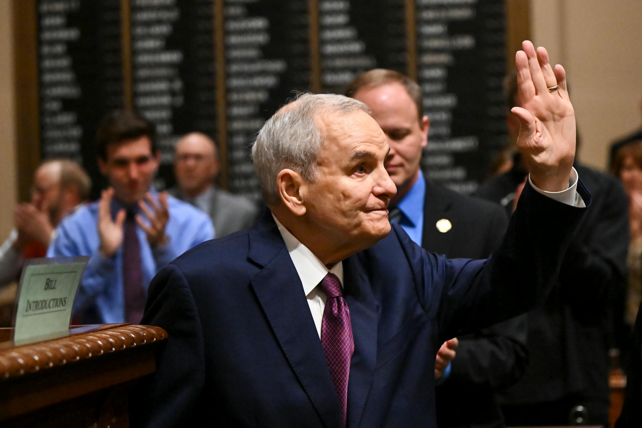 Former Minnesota Gov. Mark Dayton, the distinguished guest of the night, is recognized in the house chambers before the State of the State address.