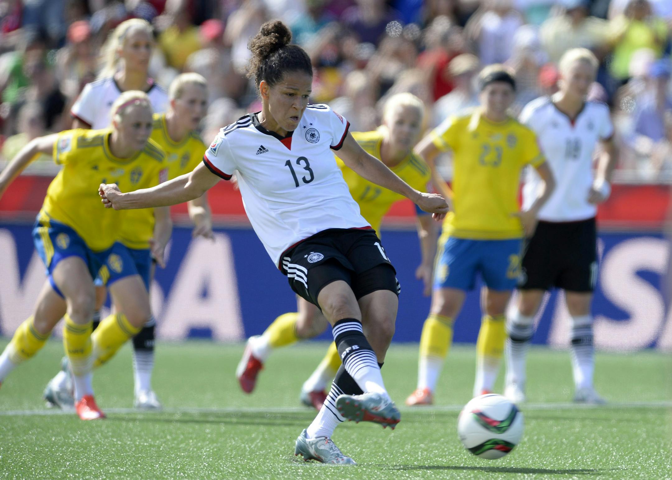 Germany's Celia Sasic (13) kicks the ball on a penalty kick to score against Sweden during the first half of a FIFA Women's World Cup soccer game in Ottawa, Ontario, on Saturday, June 20, 2015. (Justin Tang/The Canadian Press via AP) MANDATORY CREDIT