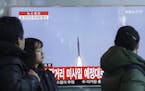 South Koreans watch a TV news program with a file footage about North Korea's rocket launch at Seoul Railway Station in Seoul, South Korea, Sunday, Fe