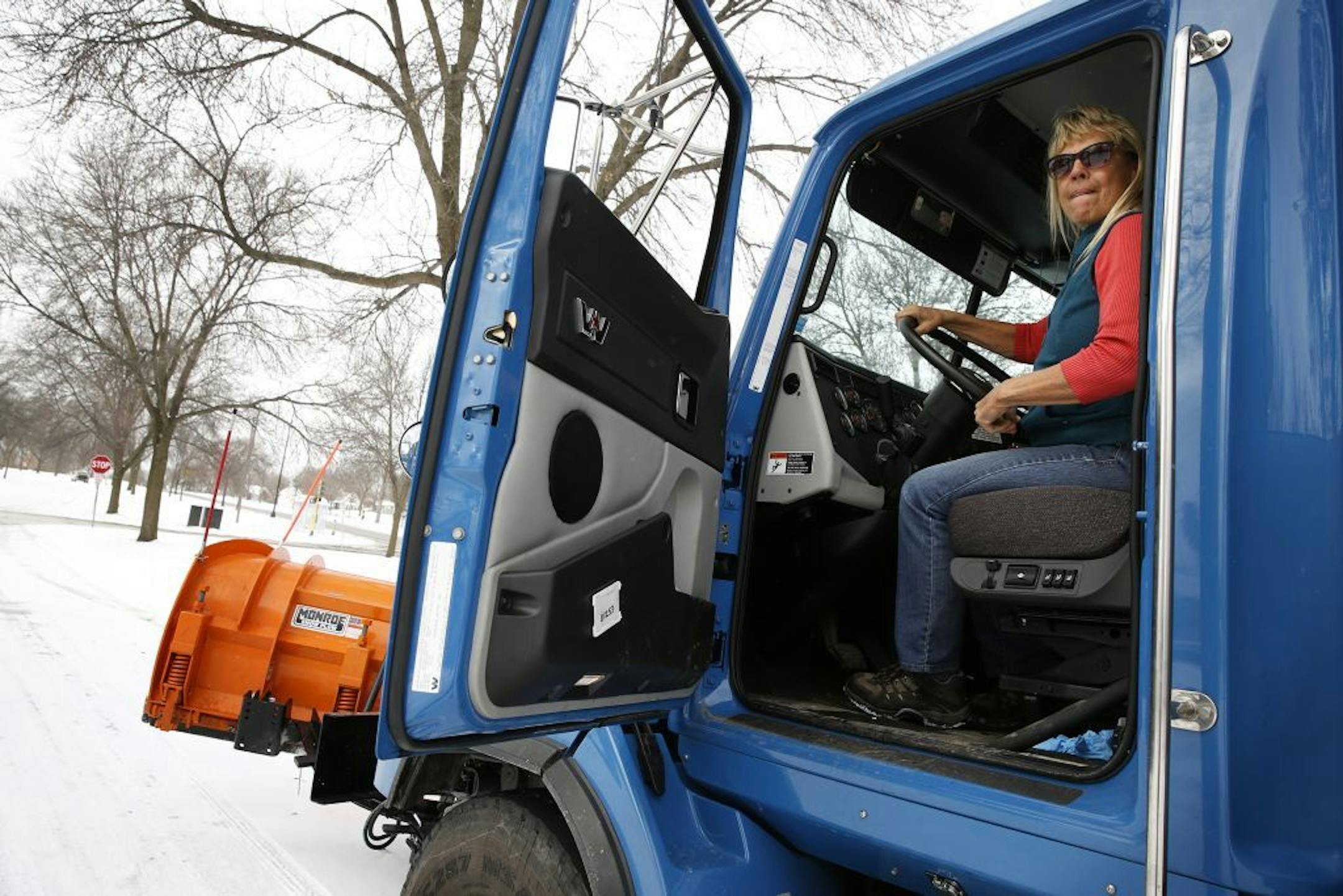 City of Minneapolis truck driver Vicky Stich plows snow and lays down sand and salt on Olson Highway Service Road in Minneapolis on Tuesday, November 11, 2014. Stich has been driving a truck for the city for 38 years.