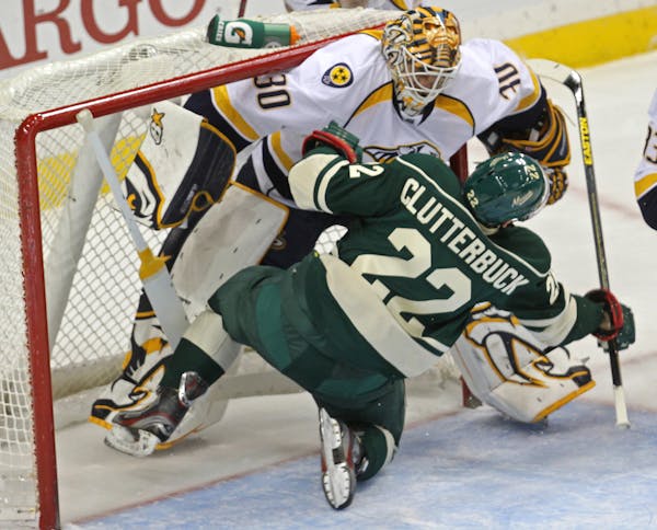 Nashville goalie Chris Mason and Wild's Cal Clutterbuck crashed in first period action.