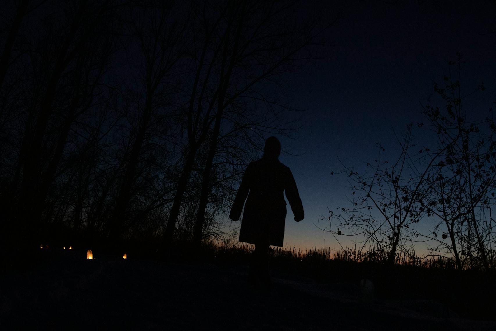 A woman walked along the candlelit luminaries paths at Wood Lake Nature Center in 2019.