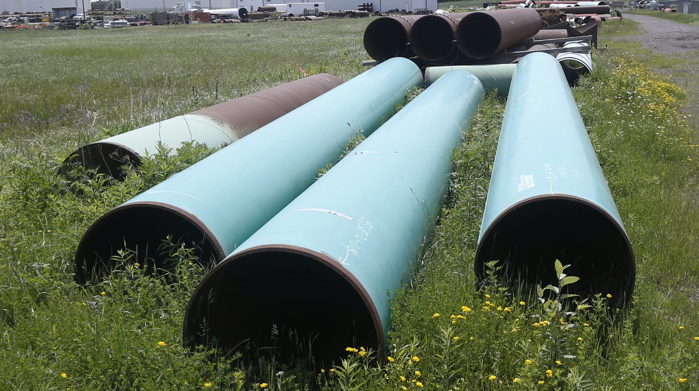 FILE - In this June 29, 2018 file photo, pipeline used to carry crude oil is shown at the Superior terminal of Enbridge Energy in Superior, Wis. An updated environmental review released by a state agency Monday, Dec. 9, 2019, found no serious threat to Lake Superior if crude oil ever leaked from a new pipeline to replace Enbridge Energy's aging Line 3 across northern Minnesota. (AP Photo/Jim Mone, File)