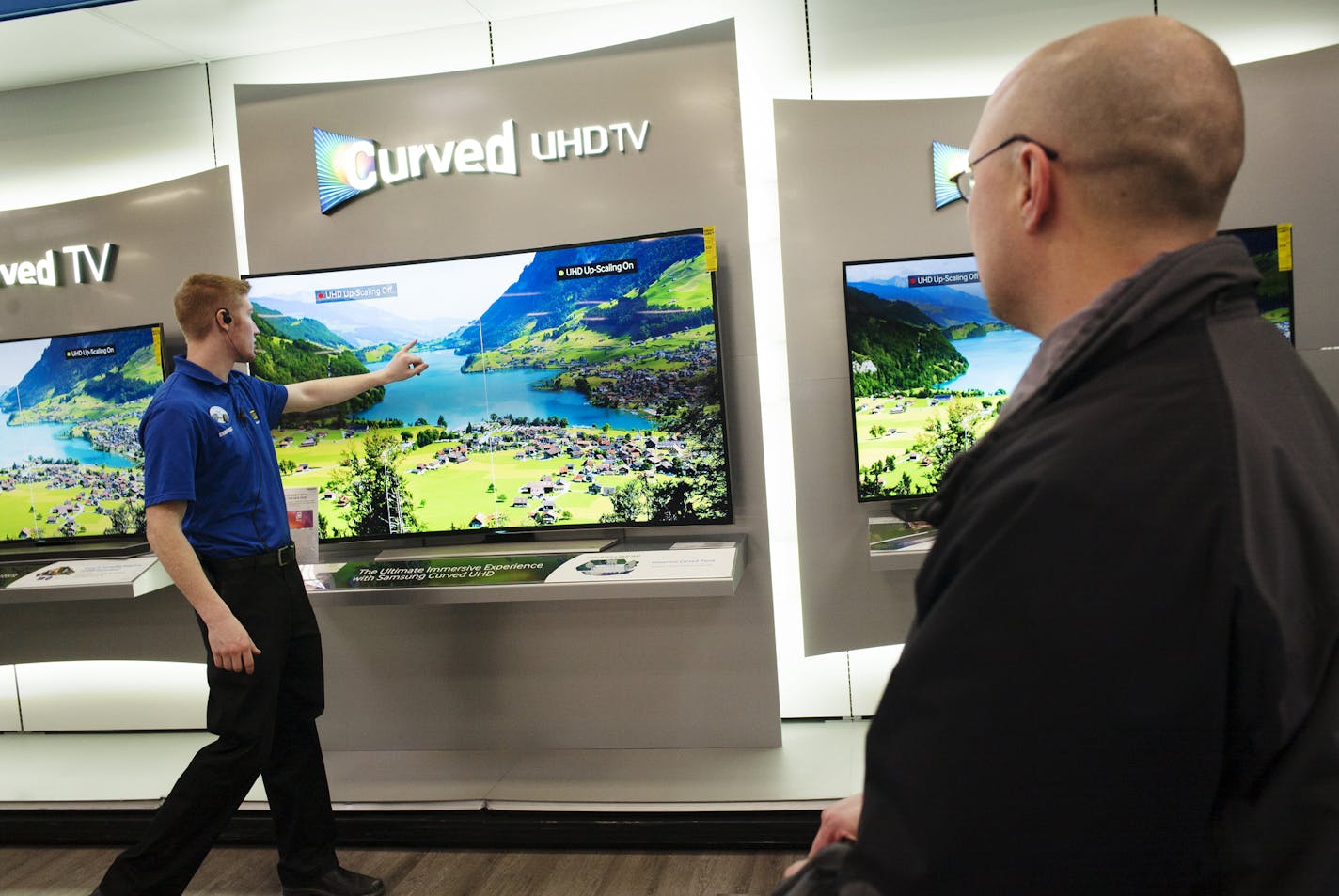 At the Best Buy store in Minnetonka, 4k televisions. They were all the buzz of the Consumer Electronics Show and will likely be a big selling point during the Super Bowl TV buying spree. Sales person Rhett Bjork was pointing out the finer points of the Samsung UHD set to vendor Andrew Kestly. ] Richard Tsong-Taatatarii@startribune.com