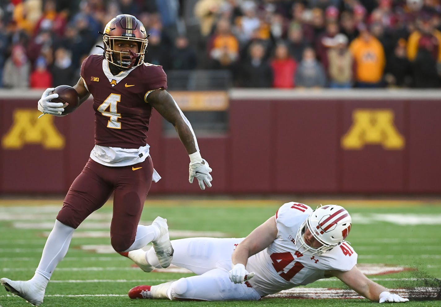 Minnesota Gophers running back Mar'Keise Irving (4) breaks a tackle by Wisconsin Badgers linebacker Noah Burks (41) during the second quarter of an NCAA football game between the Minnesota Gophers and the Wisconsin Badgers Saturday, Nov. 27, 2021 at Huntington Bank Stadium in Minneapolis, Minn. ] AARON LAVINSKY • aaron.lavinsky@startribune.com ORG XMIT: MIN2111271700150101