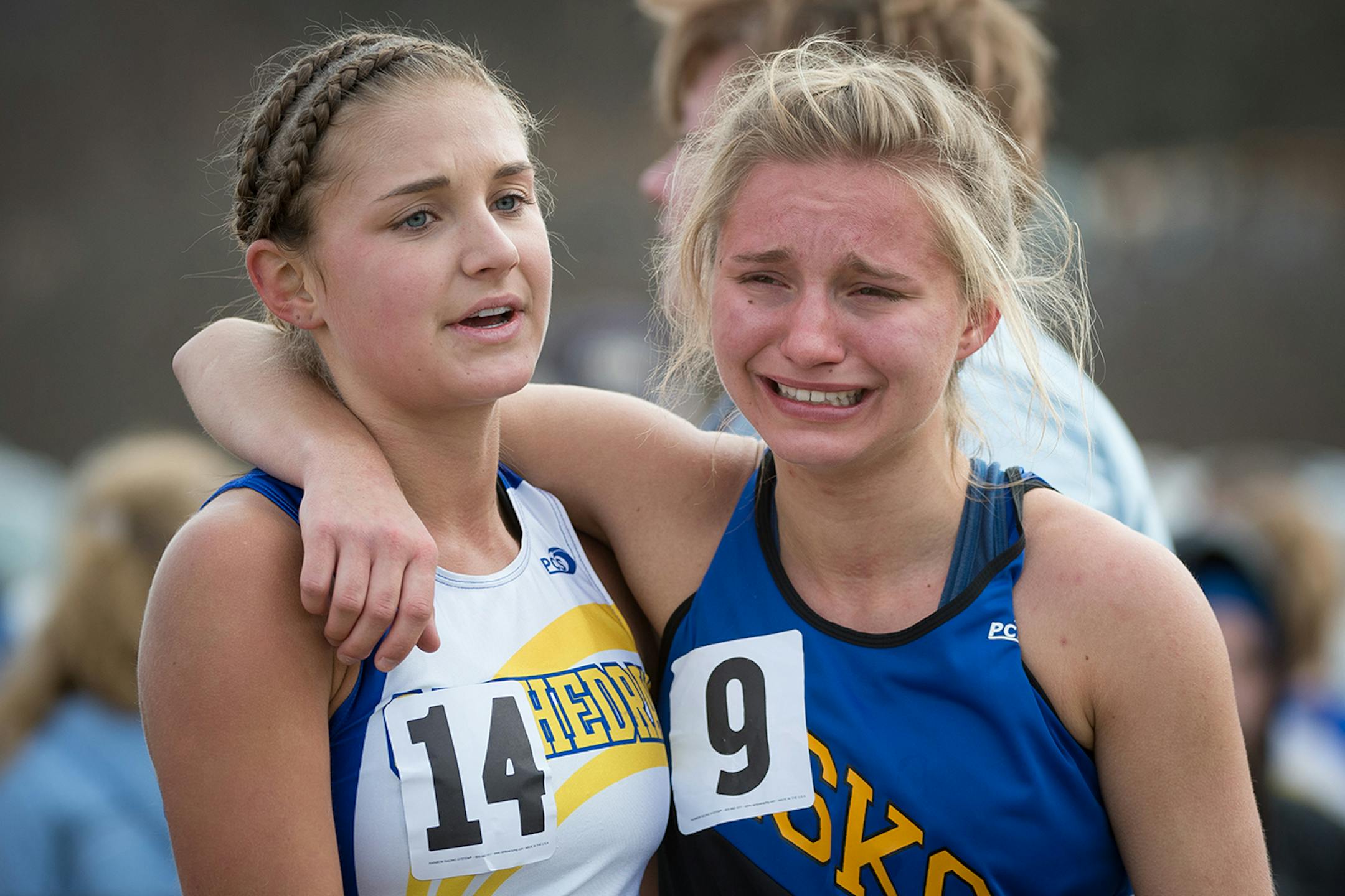 From left, Rachel Eickoff of St. Cloud Cathedral consoles Kailee Kiminski of Esko after the finish of the 1A girls' race Saturday. ] AARON LAVINSKY • aaron.lavinsky@startribune.com 1A and 2A boys' and girls' runners compete in the the Cross-country state meet on Saturday, November 1, 2014 at St. Olaf College in Northfields.