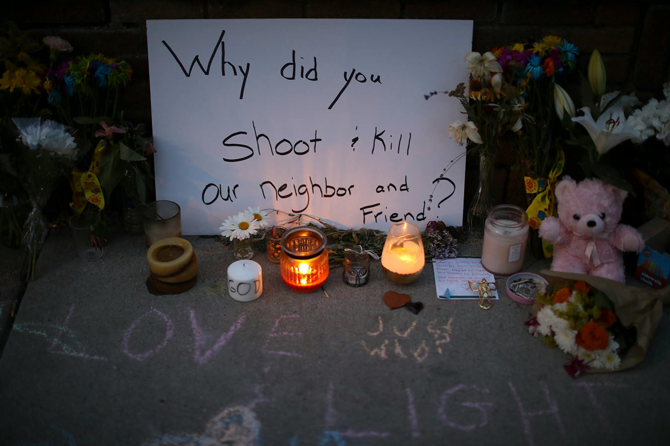 Some candles were lit as darkness fell at the memorial to Justine Damond on the sidewalk along W 51st. St. Monday night.